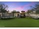 Large backyard with playground, trampoline, and lounge area at 8802 E Rimrock Dr, Scottsdale, AZ 85255
