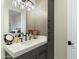 Bathroom with gray vanity, quartz countertop, and black fixtures at 8802 E Rimrock Dr, Scottsdale, AZ 85255