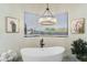 Bathroom with free-standing tub and chandelier at 8802 E Rimrock Dr, Scottsdale, AZ 85255