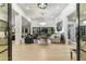 Bright and airy entryway with hardwood floors and modern light fixtures at 8802 E Rimrock Dr, Scottsdale, AZ 85255
