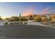 Luxury home with desert landscaping and a large driveway at 8802 E Rimrock Dr, Scottsdale, AZ 85255