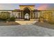 Stone facade with arched entryway and elegant staircase at 8802 E Rimrock Dr, Scottsdale, AZ 85255