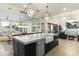 Open concept kitchen with large island, sink, and breakfast bar overlooking Gathering room at 8802 E Rimrock Dr, Scottsdale, AZ 85255