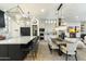 Elegant kitchen and dining area with large island and modern wood dining table at 8802 E Rimrock Dr, Scottsdale, AZ 85255