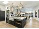 Open kitchen with large island, farmhouse sink, and views into the Gathering room at 8802 E Rimrock Dr, Scottsdale, AZ 85255