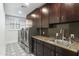 Laundry room with dark wood cabinets and patterned flooring at 8802 E Rimrock Dr, Scottsdale, AZ 85255