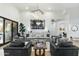 Elegant living room features a large sofa, statement artwork, and a hardwood floor at 8802 E Rimrock Dr, Scottsdale, AZ 85255