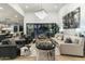 Living room with a curved sofa, pool view, and stylish decor at 8802 E Rimrock Dr, Scottsdale, AZ 85255