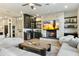 Spacious living area with stone fireplace, built-ins, and comfortable seating at 8802 E Rimrock Dr, Scottsdale, AZ 85255