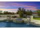 Luxury pool and spa with water features at sunset at 8802 E Rimrock Dr, Scottsdale, AZ 85255