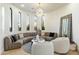 Cozy sitting room with a circular sofa and large windows offering ample natural light at 8802 E Rimrock Dr, Scottsdale, AZ 85255