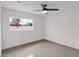 Simple bedroom with tile floors and ceiling fan at 947 N 85Th Pl, Scottsdale, AZ 85257