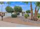 White brick ranch house with mature landscaping and a large driveway at 947 N 85Th Pl, Scottsdale, AZ 85257