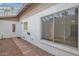 Inviting exterior features a walkway, covered patio, and large window at 947 N 85Th Pl, Scottsdale, AZ 85257