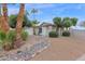 Landscaped front yard with a rock garden and mature trees at 947 N 85Th Pl, Scottsdale, AZ 85257