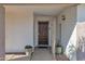 Dark wood front door with a welcoming mat and brick facade at 947 N 85Th Pl, Scottsdale, AZ 85257