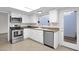 Well-equipped kitchen with stainless steel appliances and white cabinets at 947 N 85Th Pl, Scottsdale, AZ 85257