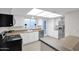 Modern kitchen featuring stainless steel appliances and ample counter space at 947 N 85Th Pl, Scottsdale, AZ 85257