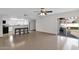 Spacious living room with tile flooring, neutral walls, ceiling fan and sliding doors leading to patio at 947 N 85Th Pl, Scottsdale, AZ 85257