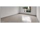 Bright and airy living area with large window and tile floor at 947 N 85Th Pl, Scottsdale, AZ 85257