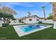 Inviting backyard with a sparkling pool, spa, and grassy area at 947 N 85Th Pl, Scottsdale, AZ 85257