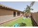Landscaped backyard with fire pit and cornhole at 10405 W Patrick Ln, Peoria, AZ 85383