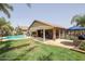 Inviting backyard oasis with a sparkling pool, patio, and pergola at 10405 W Patrick Ln, Peoria, AZ 85383