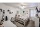 Bright bedroom with a queen bed and TV at 10405 W Patrick Ln, Peoria, AZ 85383