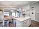 Open concept kitchen with white cabinets, quartz countertops, and an island at 10405 W Patrick Ln, Peoria, AZ 85383