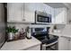 Clean and bright kitchen with white cabinets and stainless steel appliances at 10405 W Patrick Ln, Peoria, AZ 85383