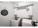 Bright laundry room with washer, dryer, and ample storage at 10405 W Patrick Ln, Peoria, AZ 85383
