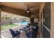 Covered patio with pool view, seating area, and ceiling fan at 10405 W Patrick Ln, Peoria, AZ 85383