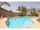 Relaxing kidney-shaped pool with decorative tile accents at 10405 W Patrick Ln, Peoria, AZ 85383