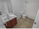 Clean bathroom with a tub, toilet and wood vanity at 11436 W Austin Thomas Dr, Surprise, AZ 85378