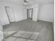 Bright bedroom with carpeted floor and double doors at 11436 W Austin Thomas Dr, Surprise, AZ 85378