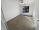 Spacious bedroom with neutral carpeting and large window at 11436 W Austin Thomas Dr, Surprise, AZ 85378