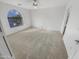 Spacious bedroom with large arched window and plush carpet at 11436 W Austin Thomas Dr, Surprise, AZ 85378