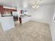 Dining area adjacent to kitchen with tile flooring at 11436 W Austin Thomas Dr, Surprise, AZ 85378