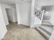 Bright entryway with tile flooring and staircase leading upstairs at 11436 W Austin Thomas Dr, Surprise, AZ 85378
