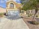 Two-story house with a white garage door and landscaping at 11436 W Austin Thomas Dr, Surprise, AZ 85378