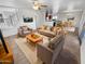 Open living area with a sofa, chairs, and dining table at 11436 W Austin Thomas Dr, Surprise, AZ 85378