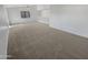 Spacious loft area with carpeted floor and large window at 11436 W Austin Thomas Dr, Surprise, AZ 85378