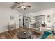 Bright living room with teal sofa and wood-look floors at 1171 E Vaughn St # A, Tempe, AZ 85283