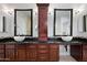 Bathroom boasts double sinks, dark wood cabinets, and large mirrors at 12544 N 120Th Pl, Scottsdale, AZ 85259