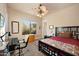Bright bedroom with a comfortable bed, a workspace, and large window at 12544 N 120Th Pl, Scottsdale, AZ 85259