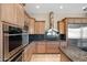 Well-equipped kitchen featuring wood cabinets and granite countertops at 12544 N 120Th Pl, Scottsdale, AZ 85259