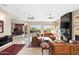 Open living room with a fireplace, large windows, and ample seating at 12544 N 120Th Pl, Scottsdale, AZ 85259