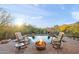 Relaxing pool area with fire pit and rocking chairs at 12544 N 120Th Pl, Scottsdale, AZ 85259