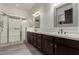 Bathroom with double vanity, shower, and large mirror at 13162 W Duane Ln, Peoria, AZ 85383