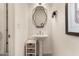 Small bathroom with pedestal sink and geometric mirror at 13162 W Duane Ln, Peoria, AZ 85383